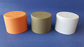 Plastic caps recieve a matte liquid painted topcoat in orange green and white. Vacuum Metallizing Limited jpg