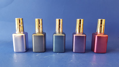 Glass nail polish bottles spray painted in various metallic finishes. Plastic caps metallized and colored gold jpg