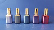 Glass bottles spray painted in light and dark silver, blue, piurple and red metallic finishes. Plastic caps metallized and colored gold. VML jpg