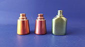 Glass bottles painted in various metallic and pearlescent finishes. Copper with red/green, purple with orange/green, silver with green. VML jpg